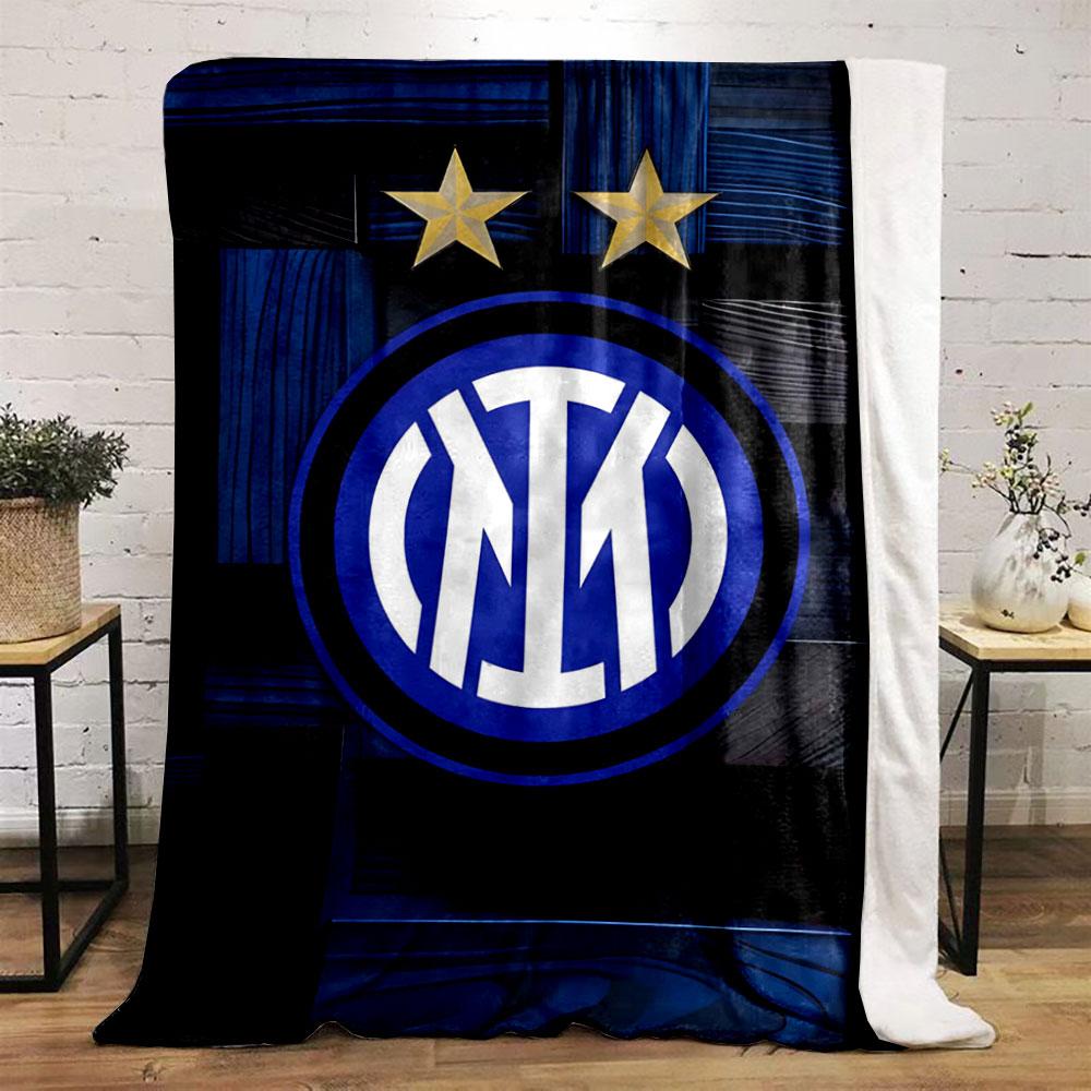 Intertwined white letters in a blue circle, two gold stars above, wood-like background. for all seasons blanket lunch break throw gift