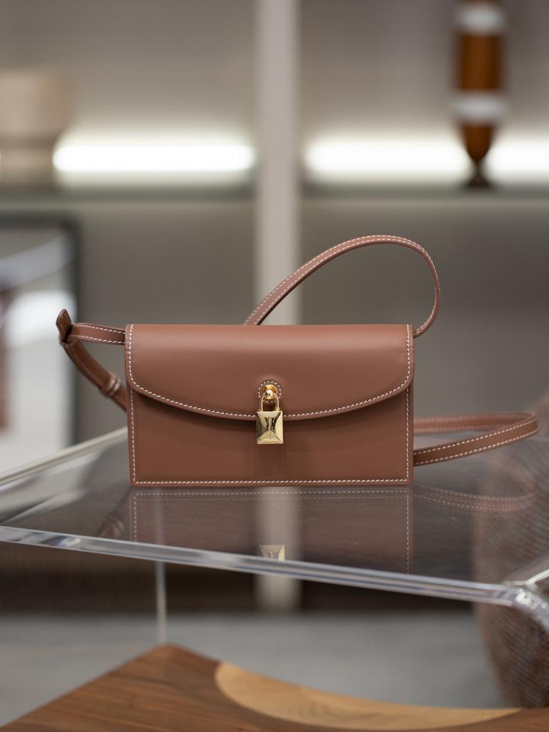 A Small Square Canvas Women's Bag with a Unique Lock and a Light Luxury Style Made of Cowhide