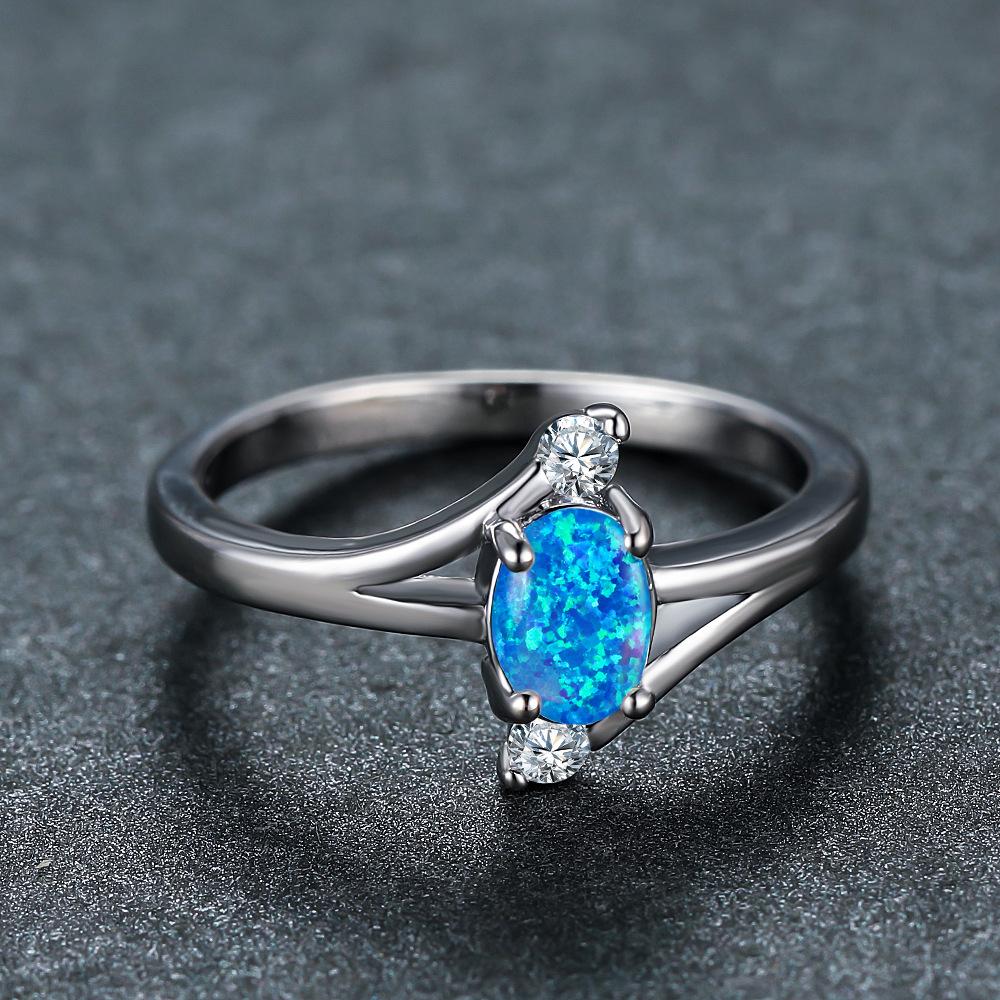 New blue opal oval platinum four-claw blue opal edge white diamond, design sense ocean wind