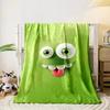 A playful green cartoon face with big eyes, teeth, and a sticking-out tongue. for all seasons blanket lunch break throw gift