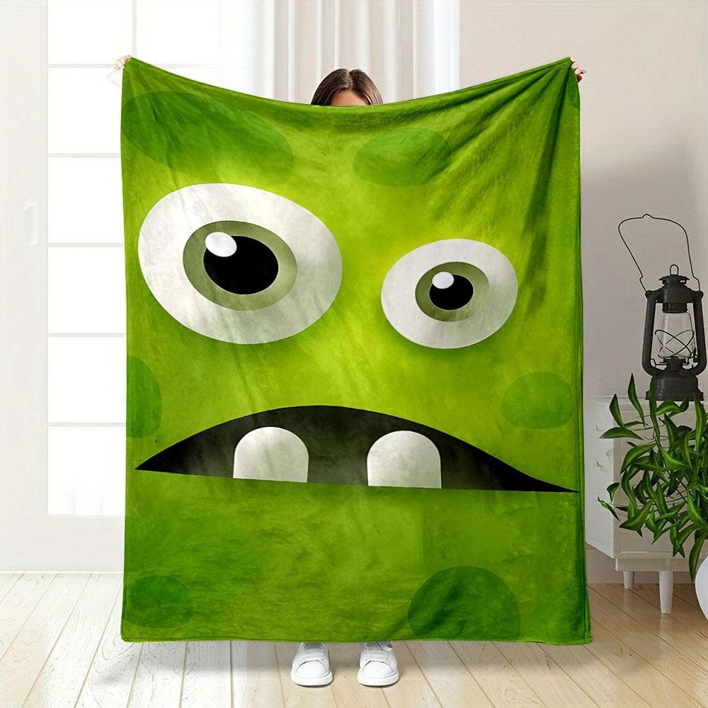 Large cartoon eyes, a dark mouth, teeth, and green textured background. for all seasons blanket lunch break throw gift