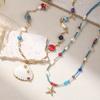 GEMCHIC Women's Ocean Style Shell Starfish Layered Necklace with Blue Beads and Pearl for Summer Vacation
