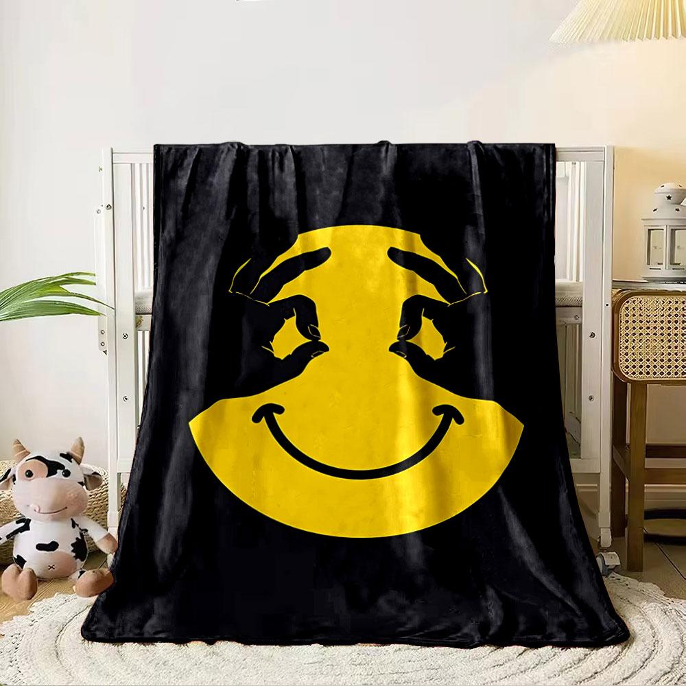A yellow smiley face with hands forming eyes on a black background. for all seasons blanket lunch break throw gift