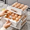 Double-layer 32-grid drawer-style egg storage box made of PET and PP. Space-saving fridge organizer keeps eggs fresh and neatly arranged.