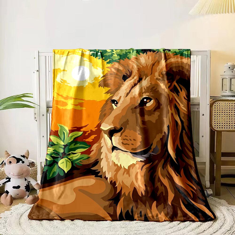 A majestic lion with a vibrant orange sunset and green foliage background. for all seasons blanket lunch break throw gift